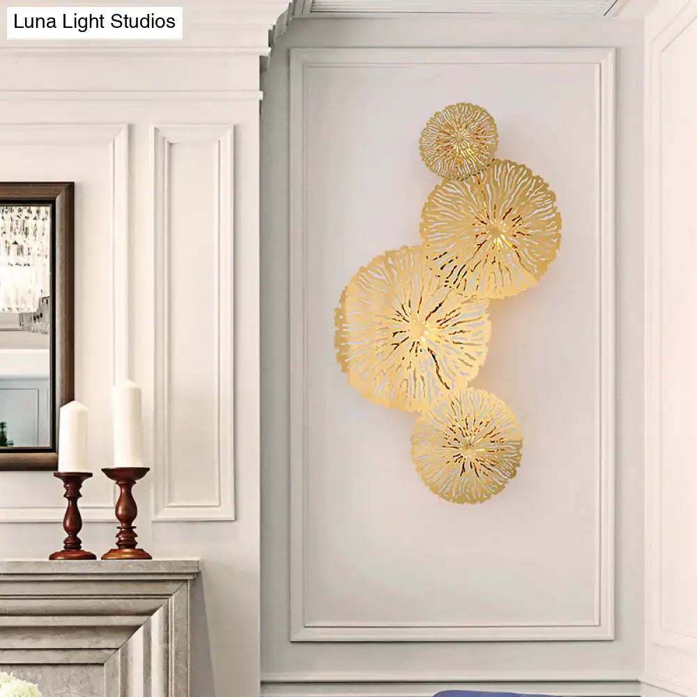 Artistic golden lotus leaf sconce light fixture with four overlapping metallic sunburst discs for living room wall art