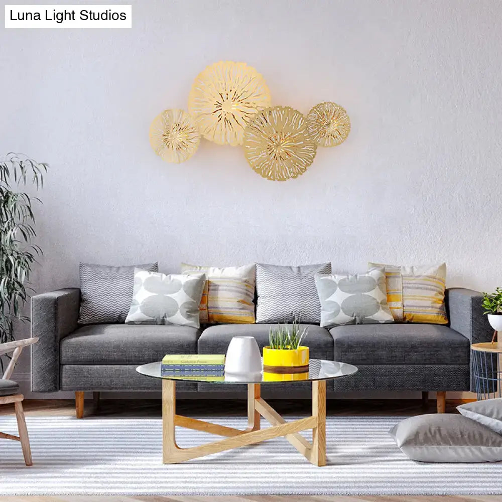 Artistic golden lotus leaf sconce light fixture with intricate circular radial patterns for living room wall art