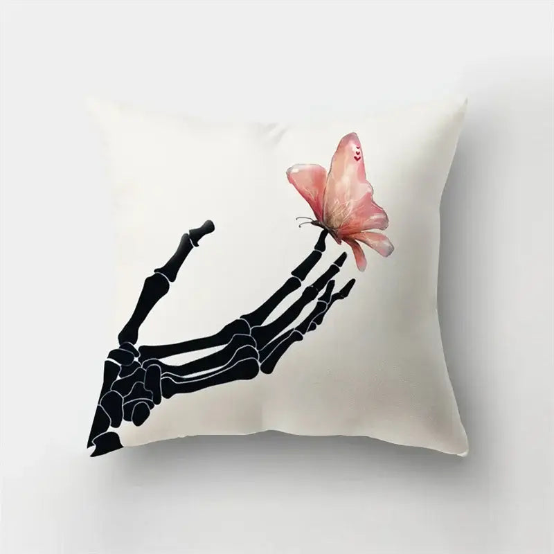 Cream-colored short plush throw pillow with a black skeletal hand holding a pink butterfly, perfect for decorbites deer animal decor