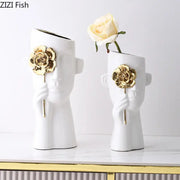 Artistic white ceramic head vases with gold rose relief and sculpted hands holding the flower for bedroom decor