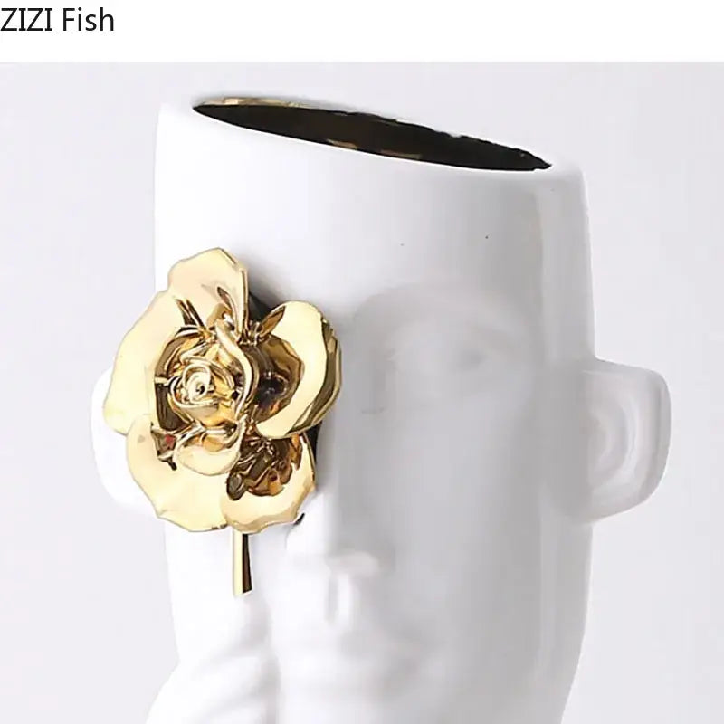 Artistic white ceramic vase shaped like a face with a gold rose relief brooch for bedroom decor