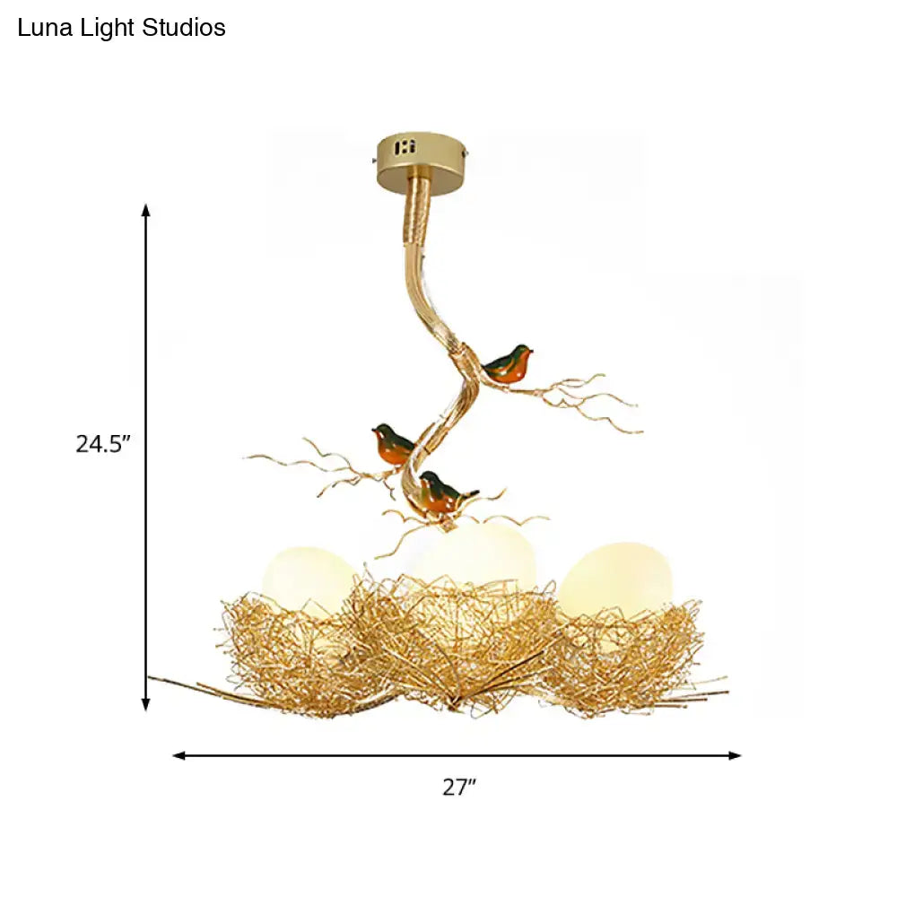 Gold-toned decorbites™ chandelier pendant with milk white glass balls, bird-themed aluminum nest, and branch design