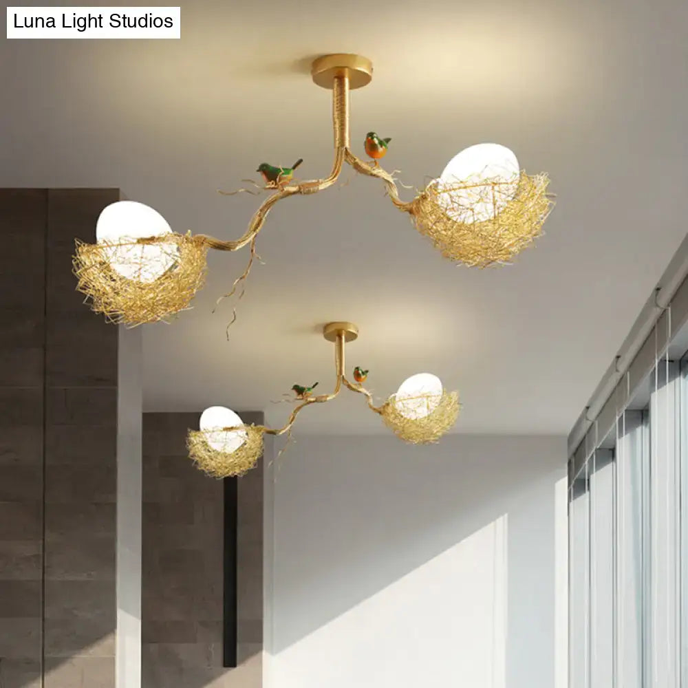 Gold-toned DecorBites™ chandelier pendant with milk white glass balls and hand-sewn aluminum nests with birds