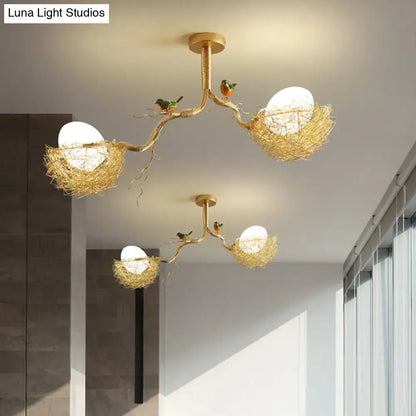 Gold-toned chandelier pendant with artistry milk white glass balls and hand sewn aluminum nests adorned with birds