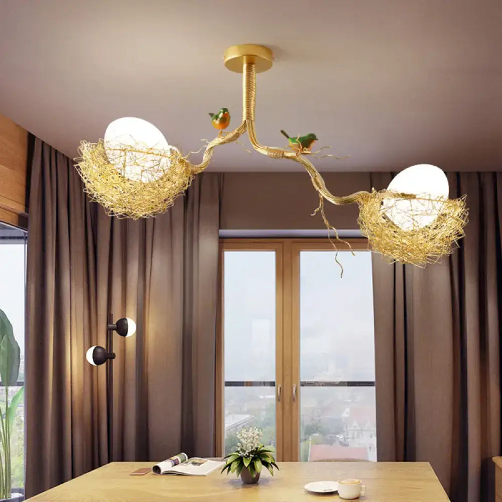 Golden chandelier pendant with artistry milk white glass balls in woven aluminum nests with colorful birds