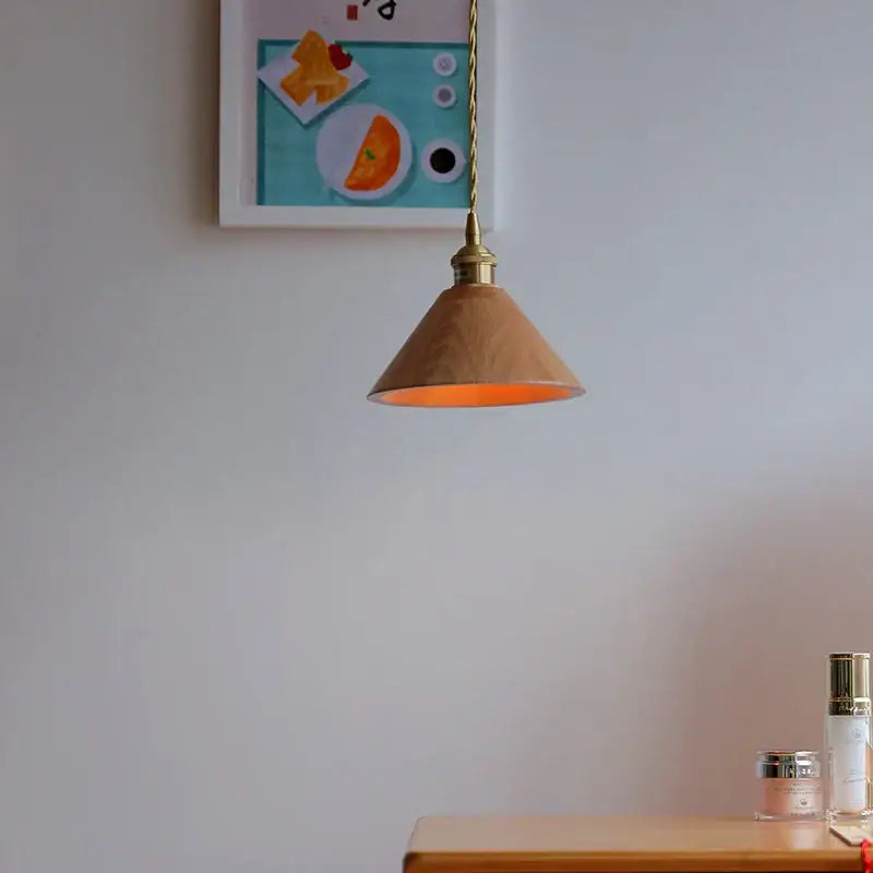 A warm-toned ash wood dome pendant lamp with a brass-finished fixture perfect for kitchen decorbites ash wood lighting