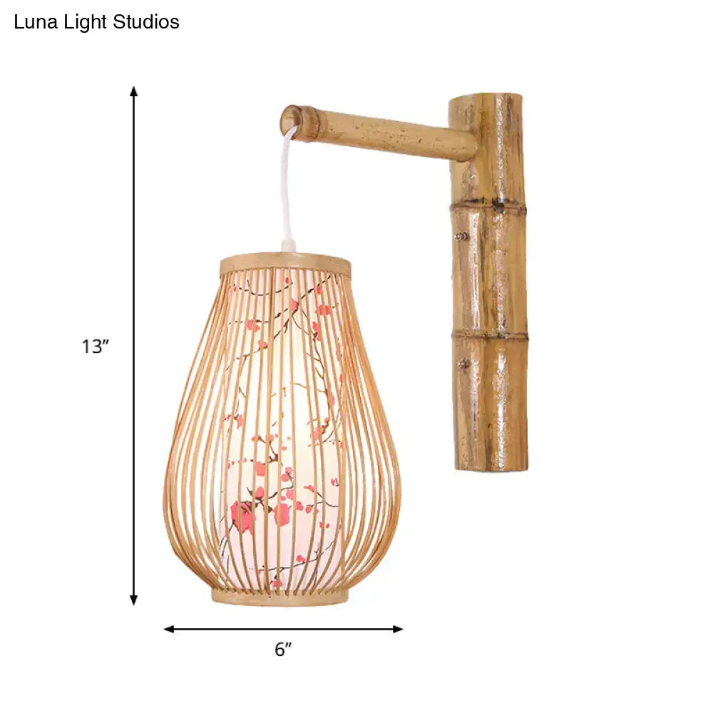 Asian pink cherry blossom bamboo teardrop sconce wall lamp with woven finish and translucent inner lining for bedroom use