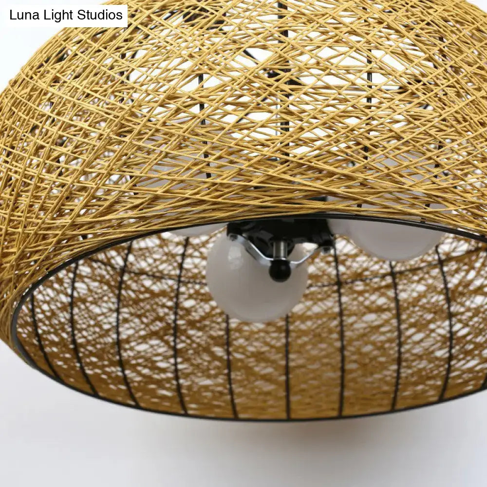 Asian rattan dome pendant light with golden woven rattan, black metal frame, and three white e26 e27 bulb base sockets