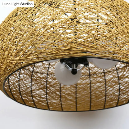 Asian rattan dome pendant light with golden woven rattan, black metal frame, and three white e26 e27 bulb base sockets