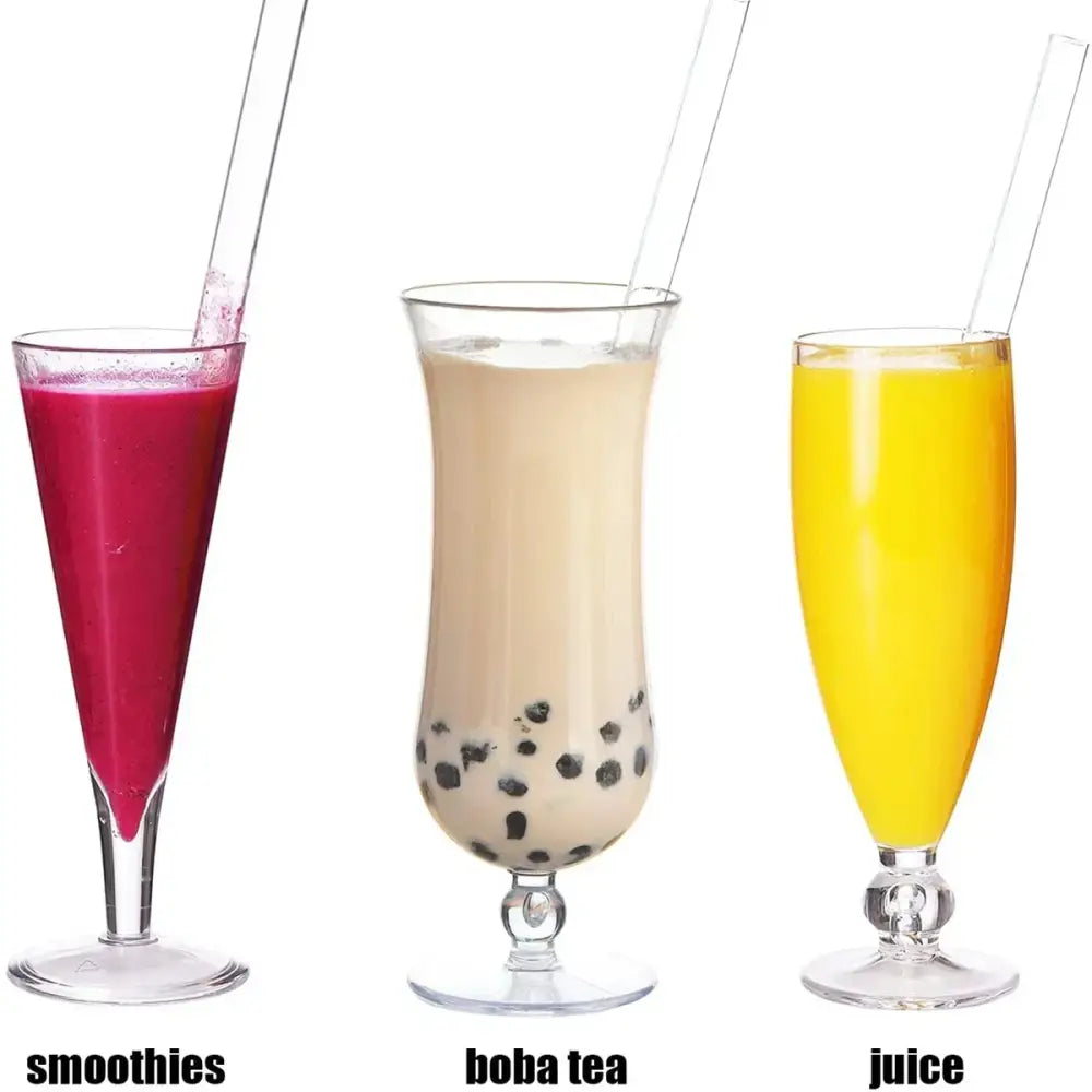 Three tall clear glass tumblers with decorbites clear glass smoothie straws filled with pink smoothie boba tea and yellow juice