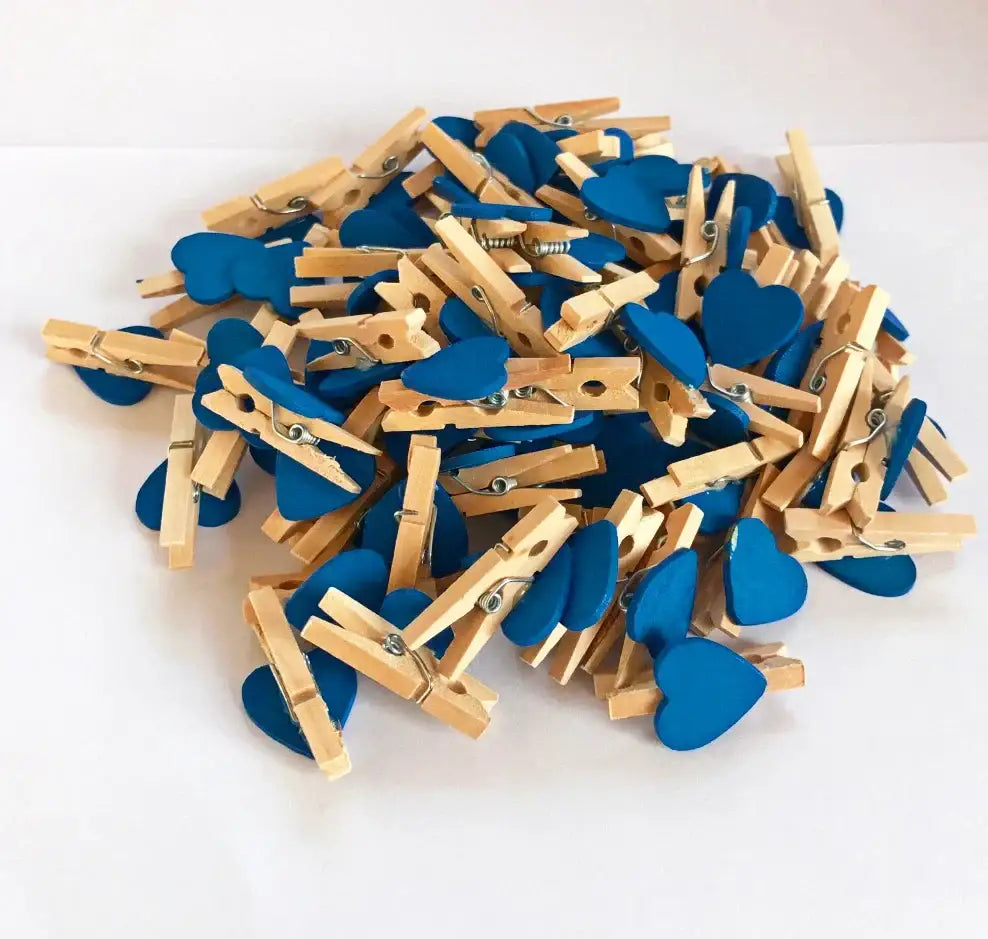 Blue heart-shaped wooden clips with natural wood handles and metal springs for bedroom photo decor use