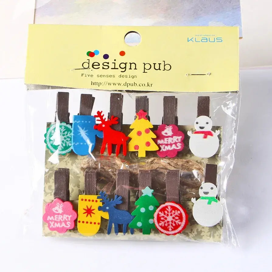 Assorted colorful christmas-themed mini wooden clips with festive designs like reindeer and merry xmas messages for decor