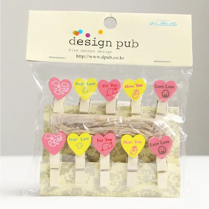 Set of six assorted colorful heart-shaped mini wooden clips with pink and yellow cartoon designs for photo decor