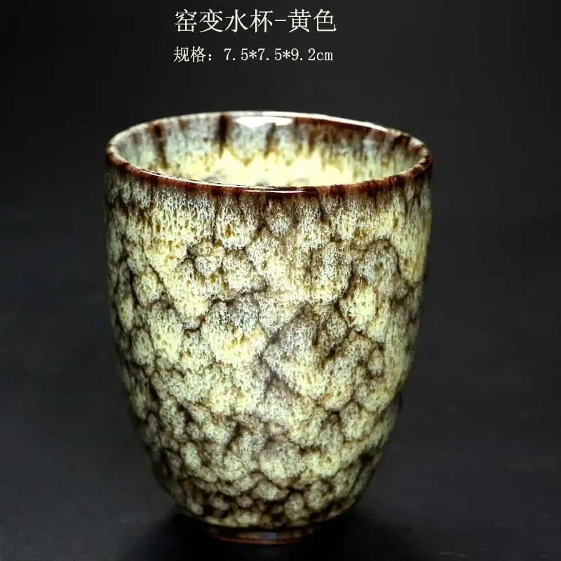 A yellow crackle-glazed ceramic kung fu tea cup with mottled surface and dark brown rim from decorbites tea cups set