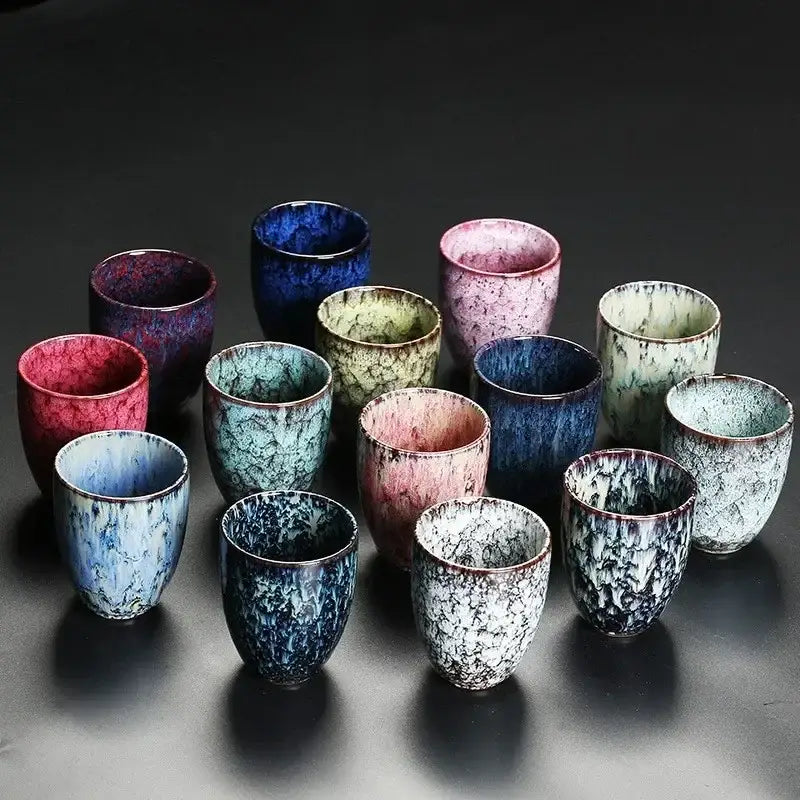 A collection of assorted crackle glaze ceramic kung fu tea cups in blue pink green and black by decorbites ceramic kung