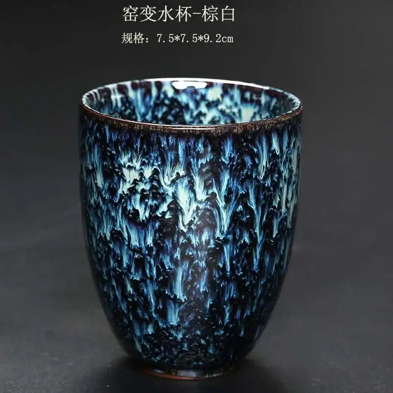 A ceramic kung fu tea cup with striking blue and white crackle glaze featuring swirling water-like patterns