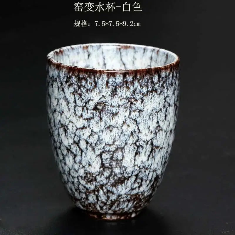 A white crackle glaze ceramic kung fu tea cup with brown speckles and textured surface from decorbites tea cups set
