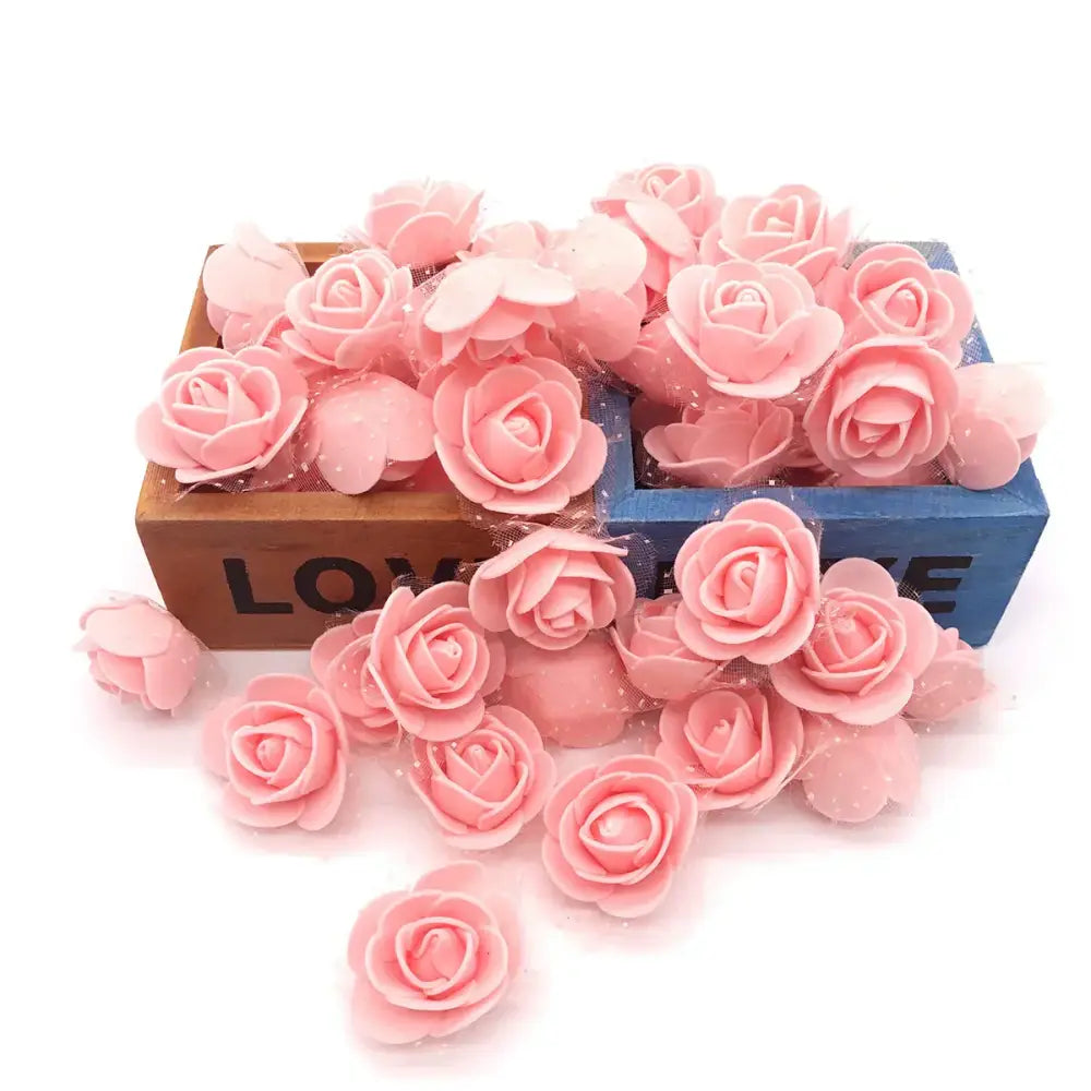 Pink handmade foam rose flower heads scattered in and around wooden boxes for wedding decor by decorbites handmade foam