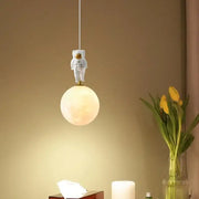 Astronaut moon white and gold led pendant light with frosted spherical globe and gold accents for bedroom use