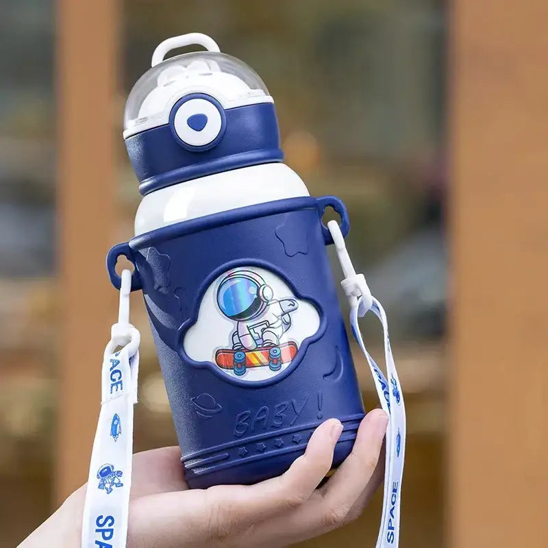 Blue astronaut-themed stainless steel thermos bottle with white strap and clear lid featuring cartoon straw design