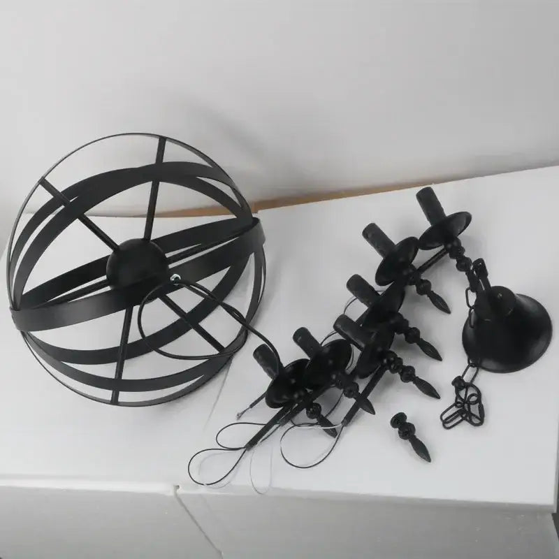 Black metal spherical iron pendant light with intersecting rings and eight candle-style bulbs for living room decorbites pendant light