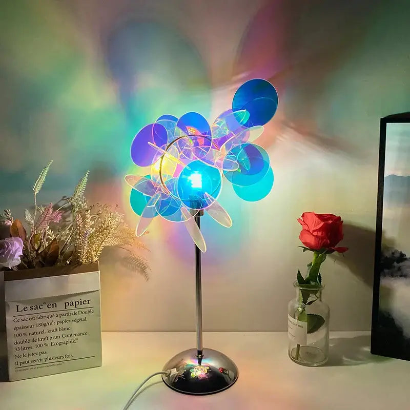 A modern aurora acrylic projection lamp with multi-colored glass and metallic base for bedroom night light use