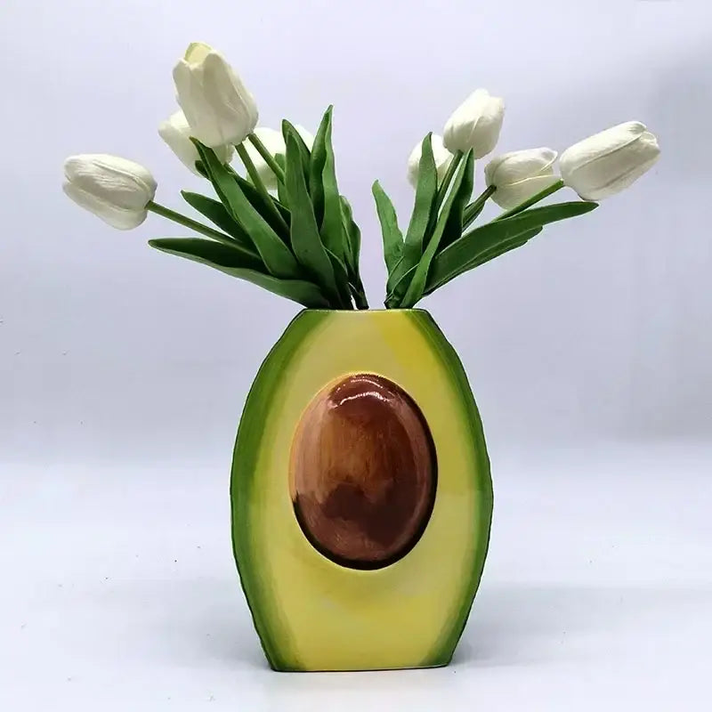 Avocado ceramic vase with glossy green and yellow exterior and realistic brown seed center for home decor