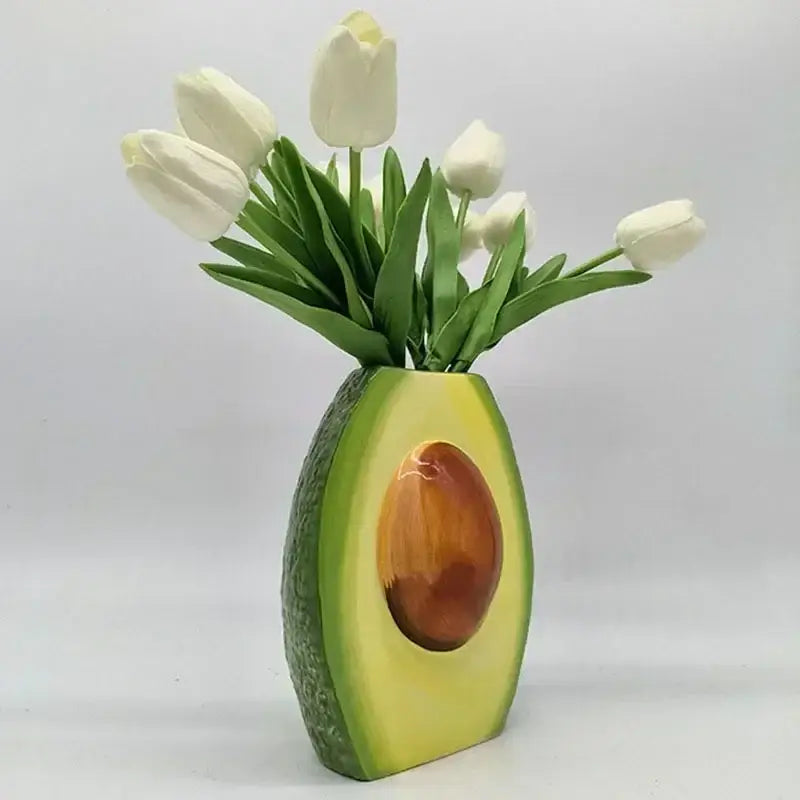 Avocado ceramic vase with glossy green exterior and brown pit holding white tulips for home decor and living room craft pot