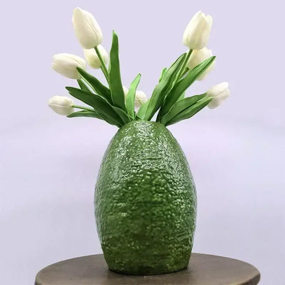 A textured deep green avocado ceramic vase with white tulips for green and yellow living room home decor