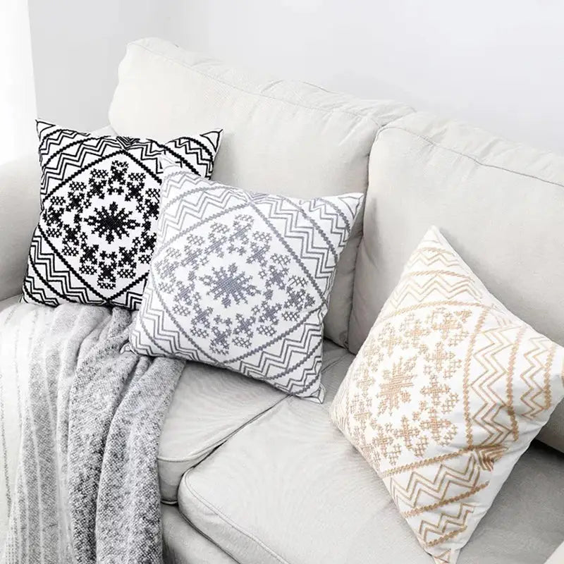 Three square throw pillows with aztec embroidery canvas cushion covers in black gray and beige tones for living room use