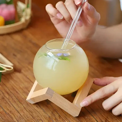 Clear glass ball shape coffee juice cocktail glass with wooden stand and straw for dining room decor