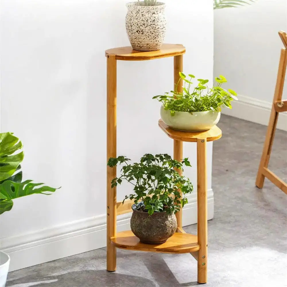 DecorBites bamboo 3 tier corner plant stand with light brown curved wooden shelves for stylish plant display