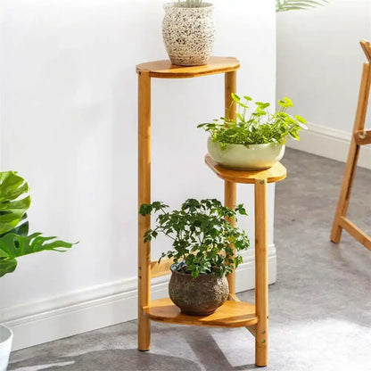 DecorBites bamboo 3 tier corner plant stand with light brown curved wooden shelves for stylish plant display