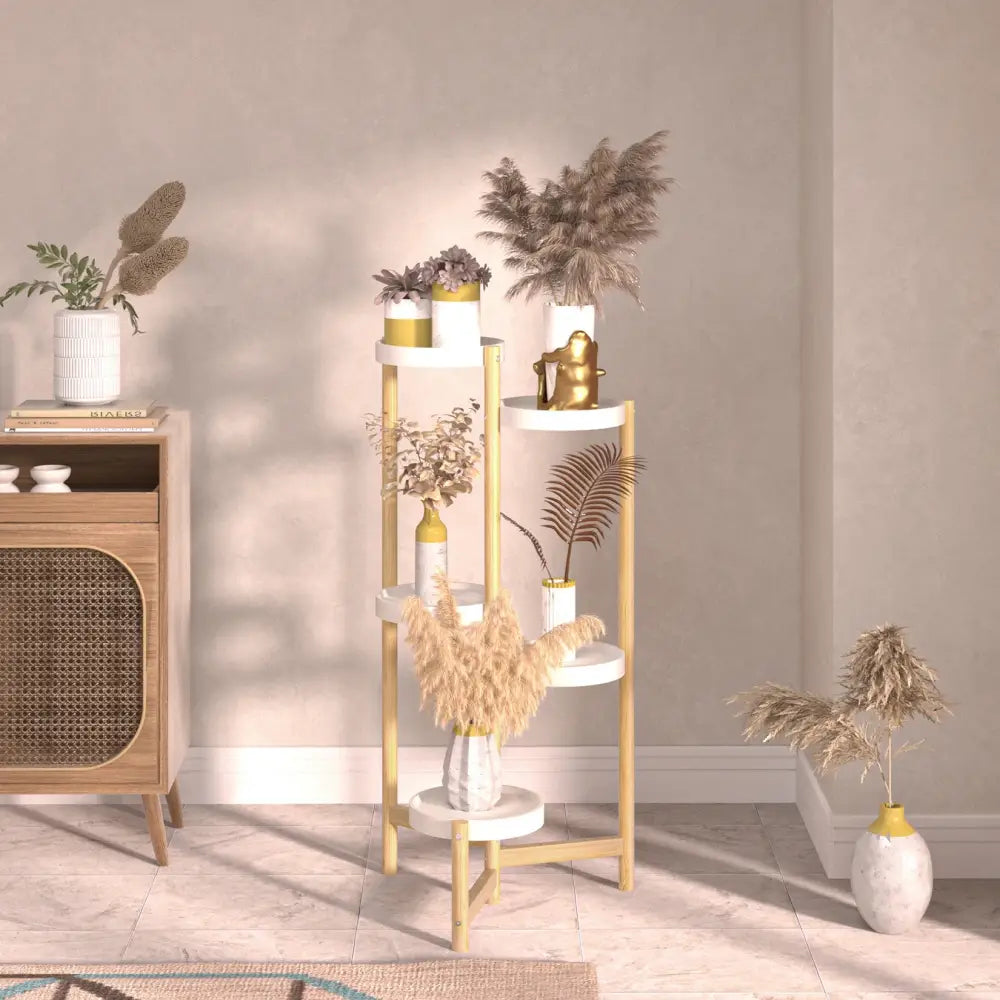Minimalist four-tiered plant stand with gold-toned metal legs and white shelves holding dried plants for indoor use