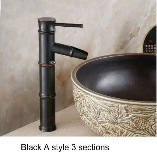 Black a-style basin mixer tap with bamboo-inspired antique brass and black design for bathroom basin use