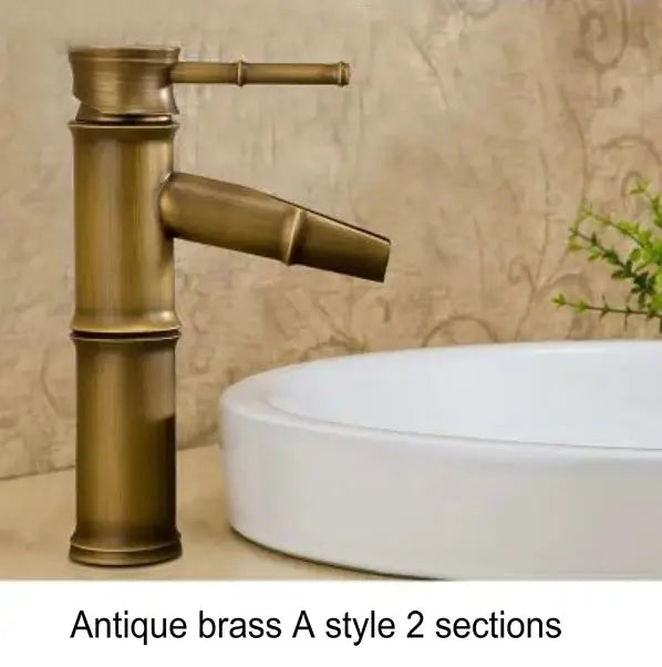 Antique brass and black basin mixer tap with bamboo-inspired design featuring two distinct sections for bathroom use