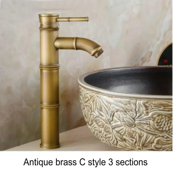 Antique brass basin mixer tap with bamboo-inspired design and three sections for bathroom basin use