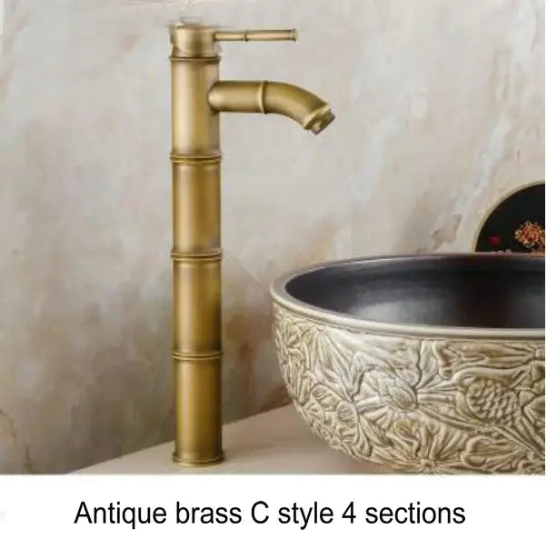Antique brass basin mixer tap with bamboo-inspired design and four distinct sections for bathroom use