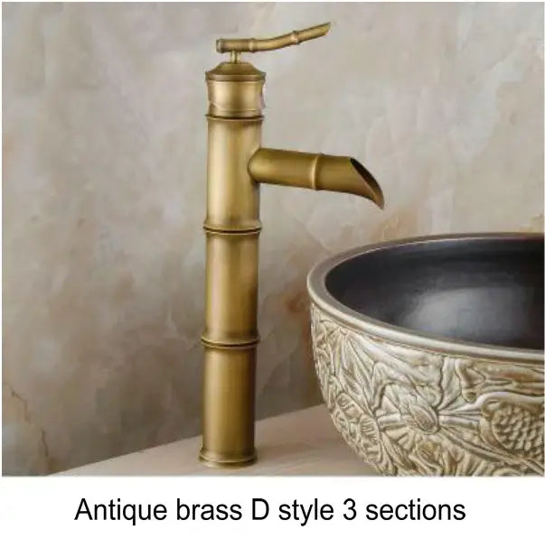 Antique brass and black basin mixer tap with bamboo-inspired design featuring three sections and curved spout