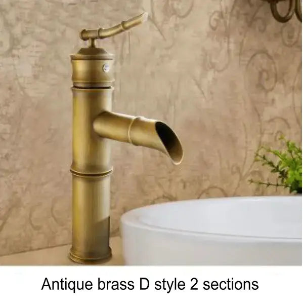 Antique brass basin mixer tap with bamboo-inspired design and black accents for bathroom basin use
