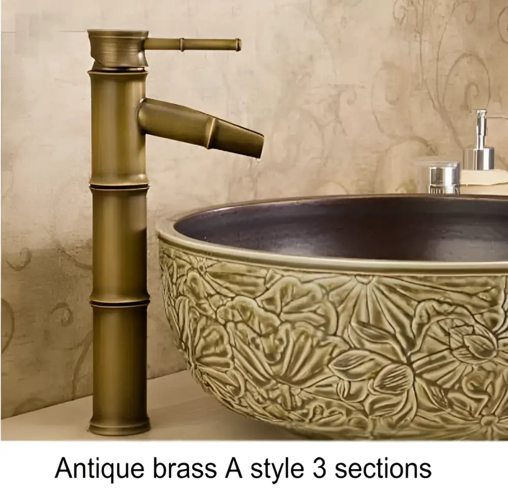 Antique brass basin mixer tap with bamboo-inspired design and three sections for bathroom basins