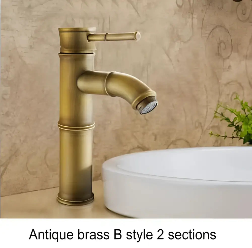 Antique brass and black bamboo-inspired basin mixer tap with two distinct sections for bathroom basin use