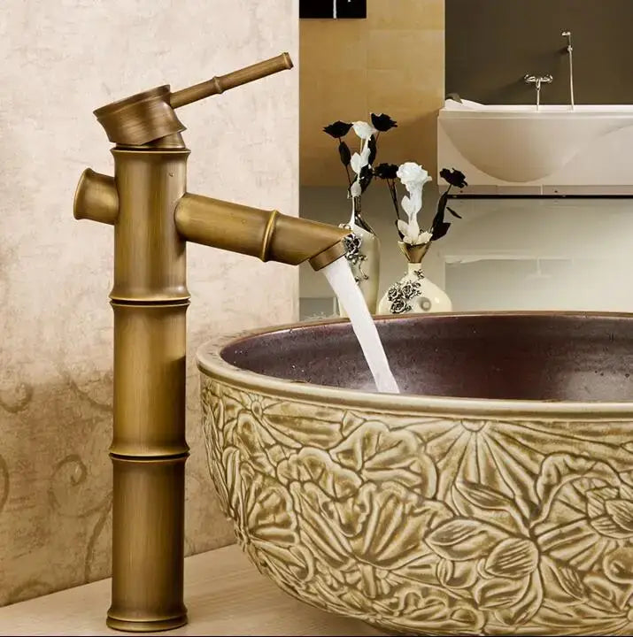 Brass bamboo-style basin mixer tap with polished antique brass finish and sleek segmented design for bathroom use