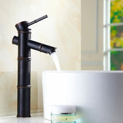 Black bamboo style high arch mixer faucet with matte finish and copper accents for bathroom waterfall use
