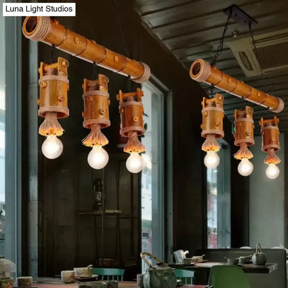 مصباح معلق على شكل دلو صيني من الخيزران من DecorBites™ - وحدة إضاءة ريفية بثلاث لمبات على شكل جزيرة باللون البني مع لمسة من الحبل