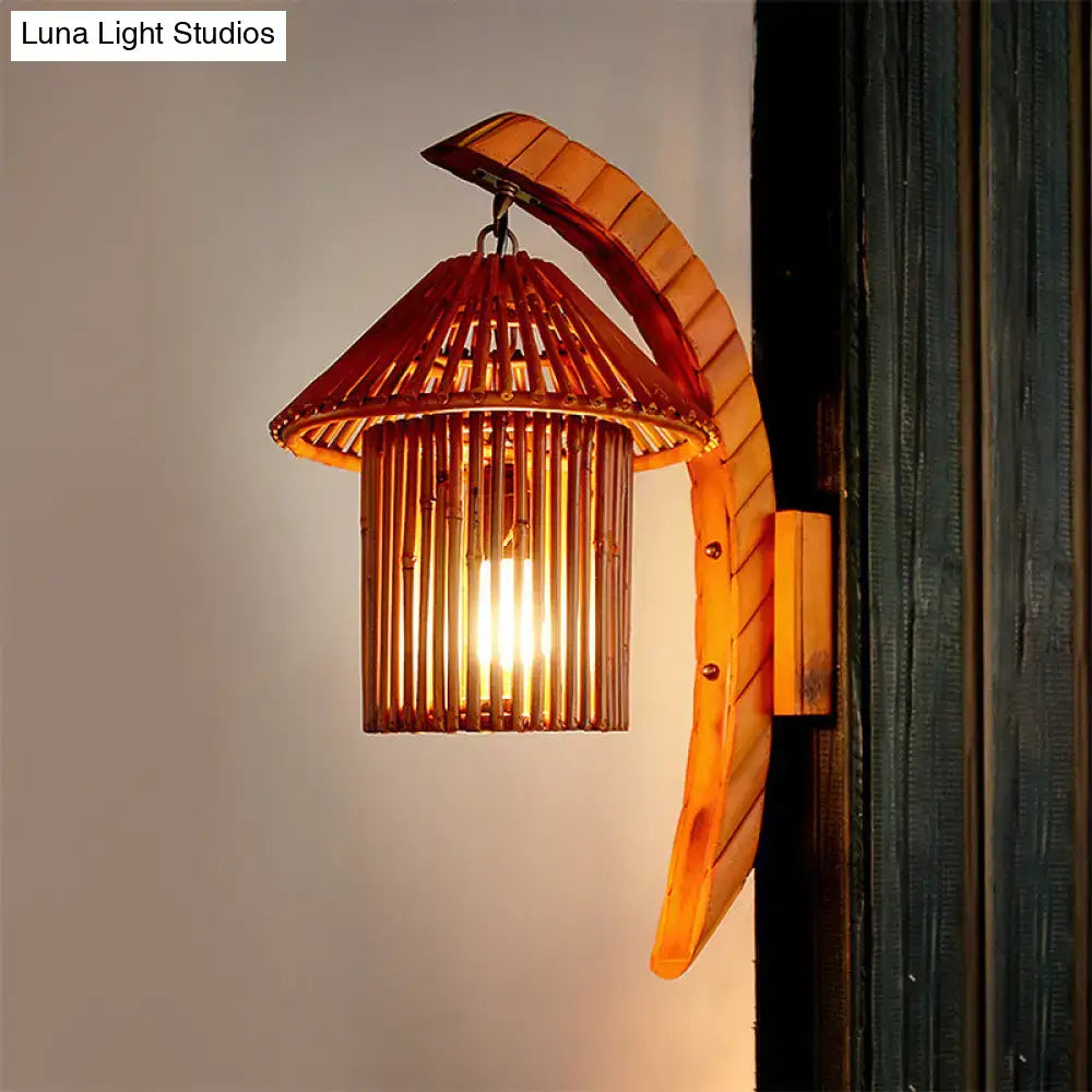 Warm-toned bamboo wall light fixture with curved leaf-like arm and conical shade for country house bedroom