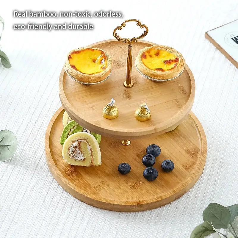 Two-tiered bamboo fruit cake stand with ornate gold-toned metal handle for elegant decorbites bamboo fruit display