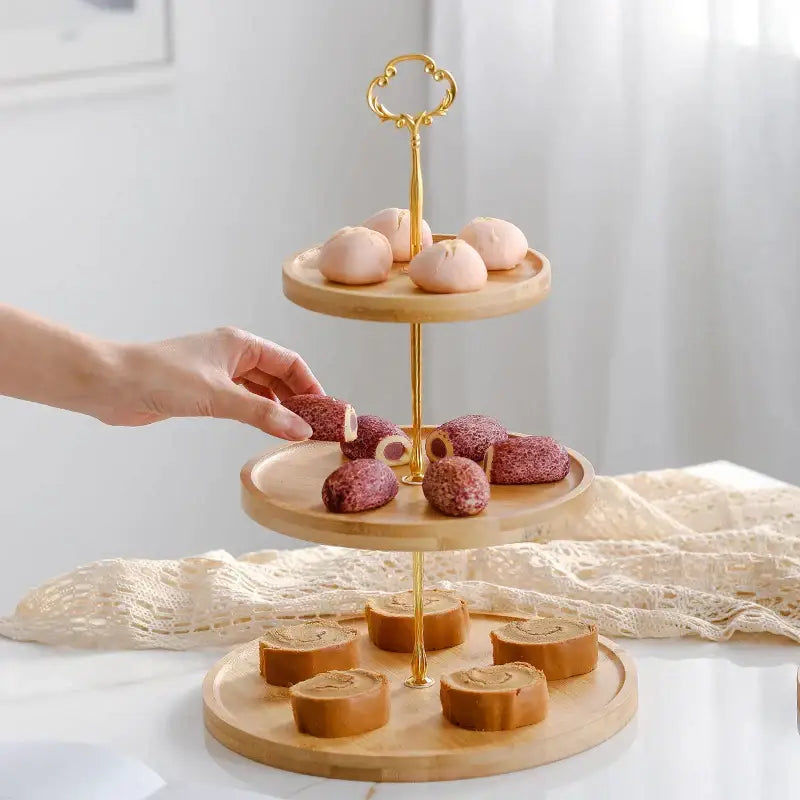 Three-tiered bamboo fruit cake stand with gold-toned metal supports and ornate key-shaped handle for decorbites bamboo fruit use