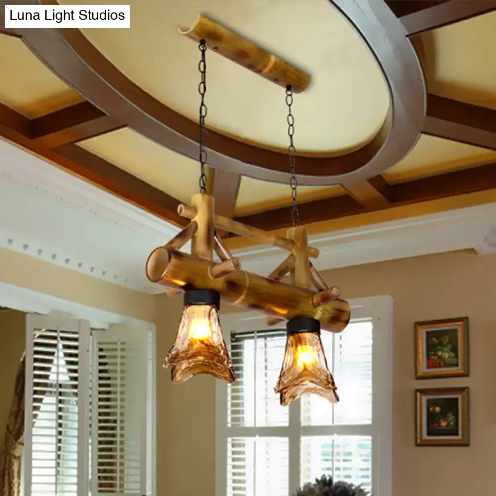 Rustic bamboo pendant light with amber glass shades and black metal accents from decorbites island lighting