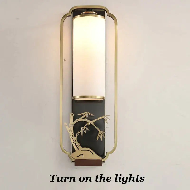 Gold-toned bamboo motif iron glass wall lamp with frosted glass cylinder on black base for bedroom decorbites iron glass